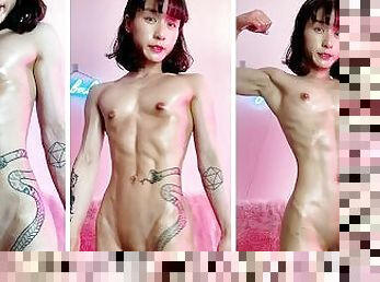 Petite and cute Asian muscle girl oils her six-pack abs and flexes