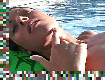 Bikini beauty goes topless to float in pool