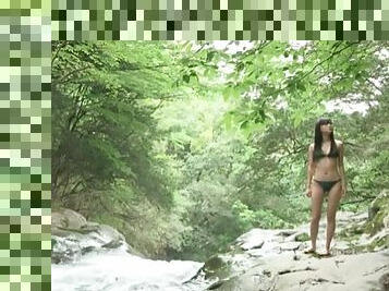Cute Japanese teen poses solo in bikini outdoors