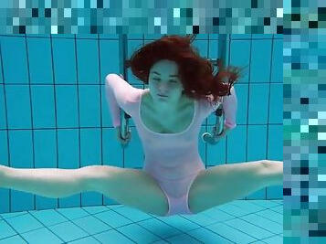 Teen in a leotard goes for a sexy swim