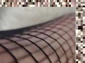 Feet and legs in fishnet stayups