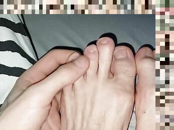 Skinny cute feet fingers stretched out bitten nails