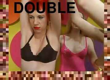Two hot sluts share a double dildo in a hot BDSM scene