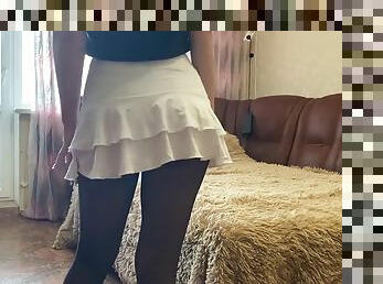 Crystal on the bed teases in a mini dress and black tights