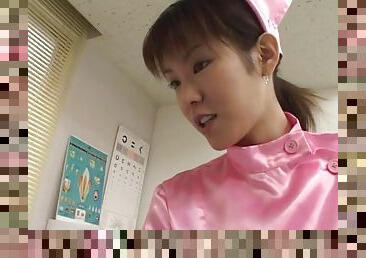 Sexy Asian nurse in pink stimulates her patient with her mouth