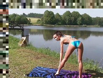 Skinny bimbo masturbates solo by the lake