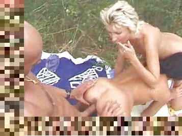 Threesome outdoors with mature slut fisted