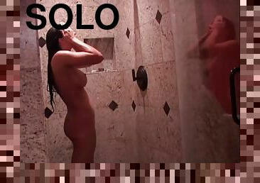 Palpitating solo model with long hair showcasing her pierced pussy in a shower at the backstage