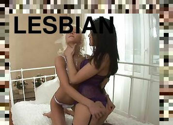 Blonde and Brunette Lesbians in Lingerie Sharing a Big Dildo