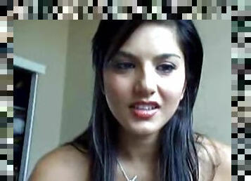 Sunny Leone toys her shaved pussy in front of a webcam