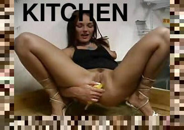 Banana fucking brunette girl in the kitchen