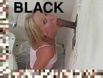 Ashley Moore clamps her mouth down on a big black cock in a gloryhole