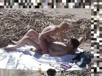 Couple fucks at the beach while guy masturbates