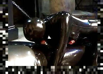 couple in black latex catsuit mask and the blowjob girl 