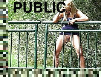 Pretty Blonde Pisses Through Railings