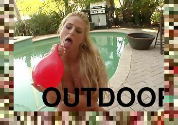 Long haired Brooke Belle plays with ballon and fetish in outdoor clip