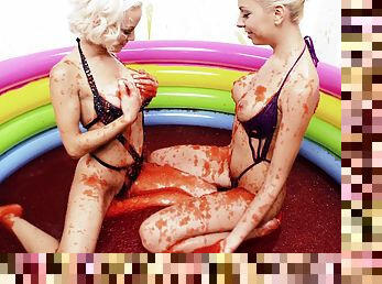 Hot blonde lesbians playing around in a pool full of syrup