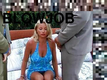 A gorgeous blonde gives two guys blowjobs at the same time