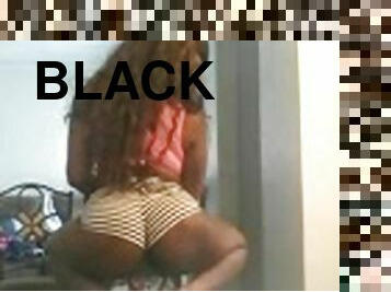 Black bitch wearing shorts shows her butt for the webcam
