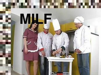 Brunette milf enjoys a gangbang with three horny cooks