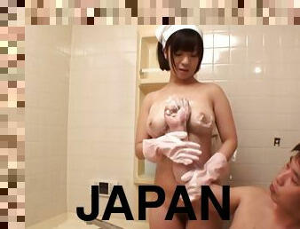 A chubby Japanese girl gives a titjob in a bathroom