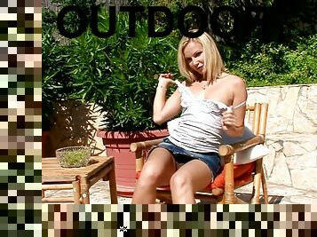 Alison the hot solo babe fingers her pussy in a backyard