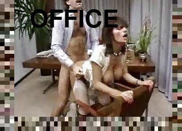 Curly office woman gets fucked on a table in retro video