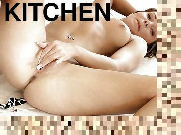 Jeny the playful blonde toys herself in a kitchen