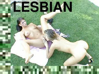 Two gorgeous lesbians fuck each other with strap on outdoors