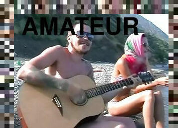 He plays guitar for her and fucks her on the beach