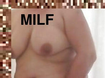 Horny milf showers and masterbates