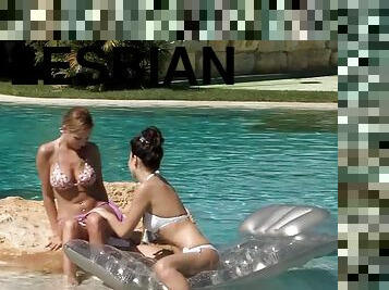 Lustful girls please each other on the lawn near the pool