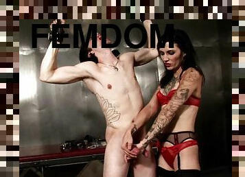 Tattooed brunette dominates and tortures her slave