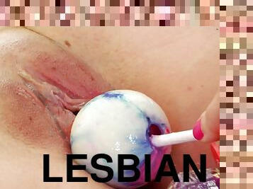 Lesbians with shaved pussies enjoy insertions using a dildo in a close up scene