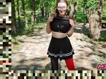 cute schoolgirl in glasses and stockings skips class while walking in central park
