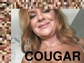 Sexy cougar sucking and fucking a big black cock in the gloryhole