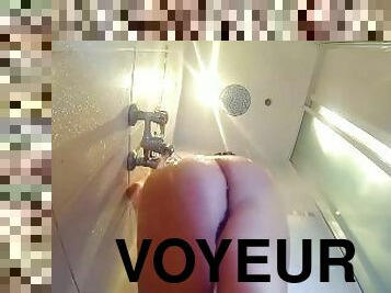 Voyeur camera in the shower. A nude girl in the shower is washed with soap.