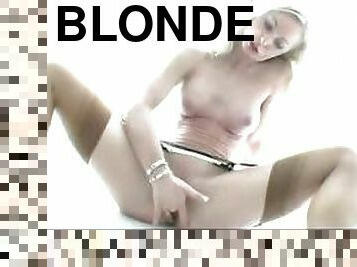 Blonde puts on stockings and masturbates