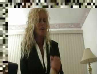 Chick in a business suit strokes cock