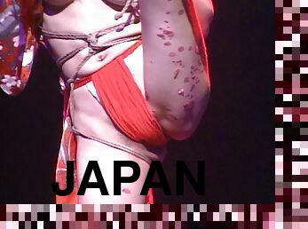 Marvelous Japanese chick in bondage entertains a crowd of people in this live on stage scene