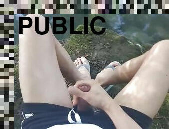 Twink wearing gray flip flops short shorts walks relaxes wanks his cock near water in public outdoor