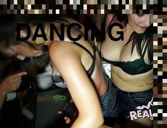 Party girls in the bar dancing and stripping for a thrill