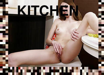 Cutie Lia Little undressed and caresses herself solo in the kitchen