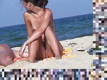 Voyeur nudist amateur couple sunbathing on the beach