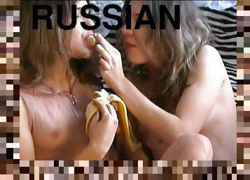 Cute Russian twins play with banana and wash in bath