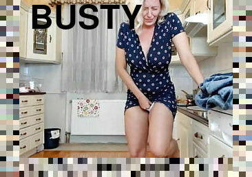 Busty MILF masturbates in the kitchen