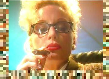 Blonde mature lady with glasses smokes a cigar and plays with her tits