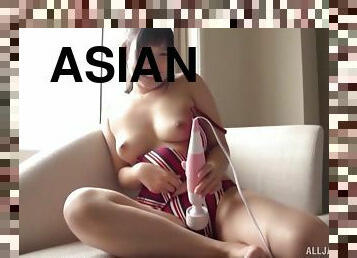 Asian masturbates alone on the couch using a big vibrator and her fingers