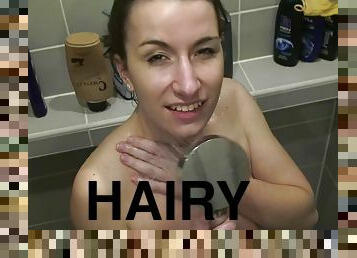 Beautiful girlfriend shows how she shampoos and washes her hairy slit while showering.