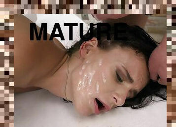 Mature brunette Kate Rich sprayed with cum on face in a MMF threesome